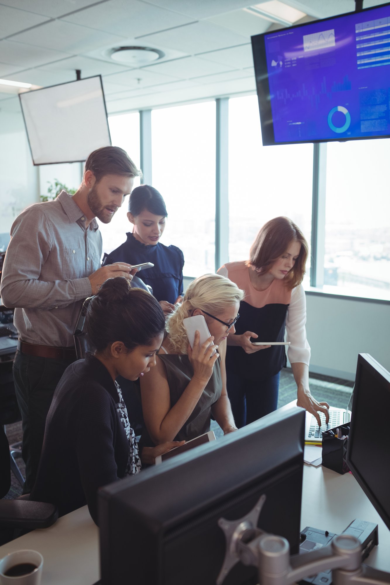 business-colleagues-working-together-while-using-t-2023-11-27-05-12-27-utc