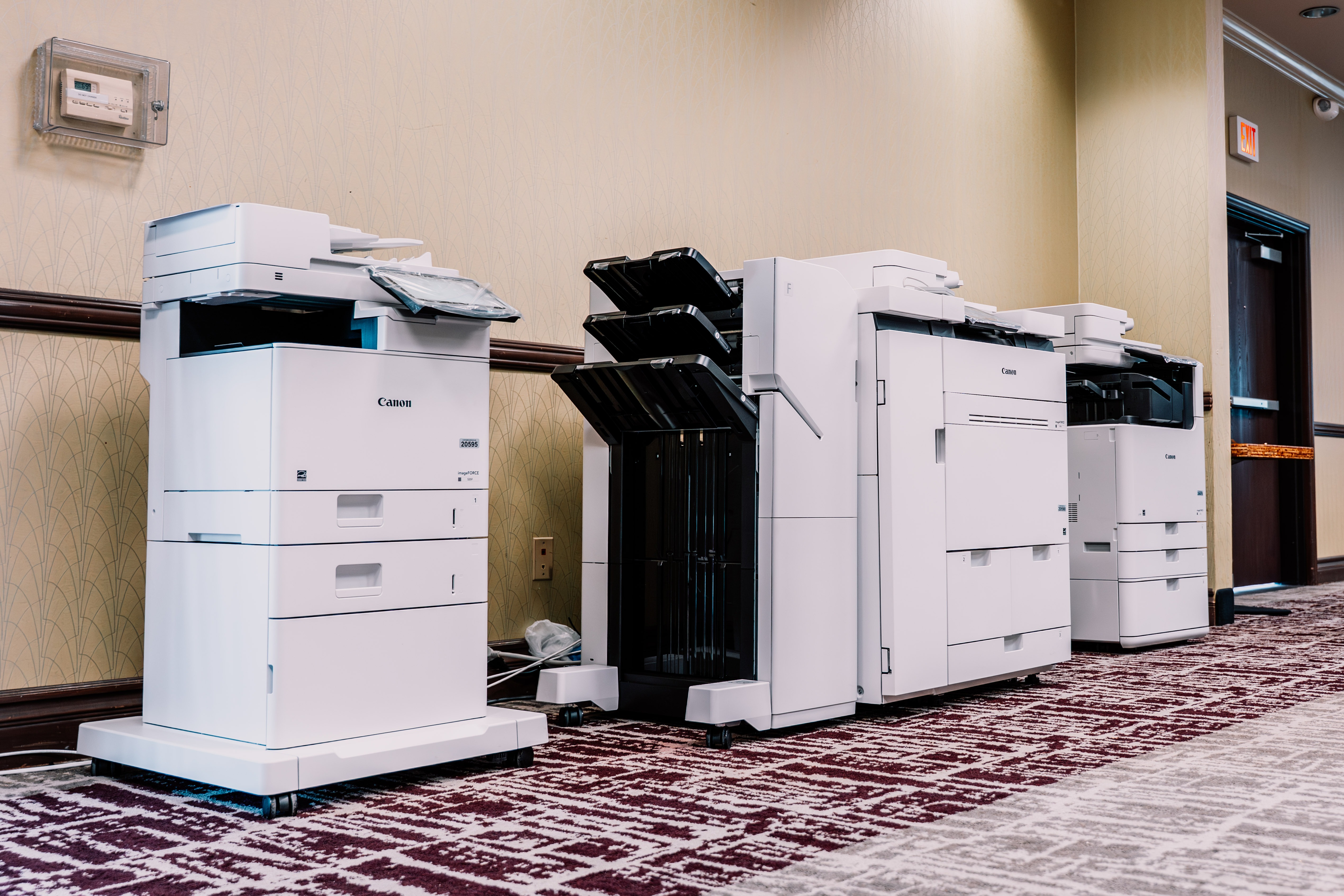 Selection of canon copiers sitting in a hallway