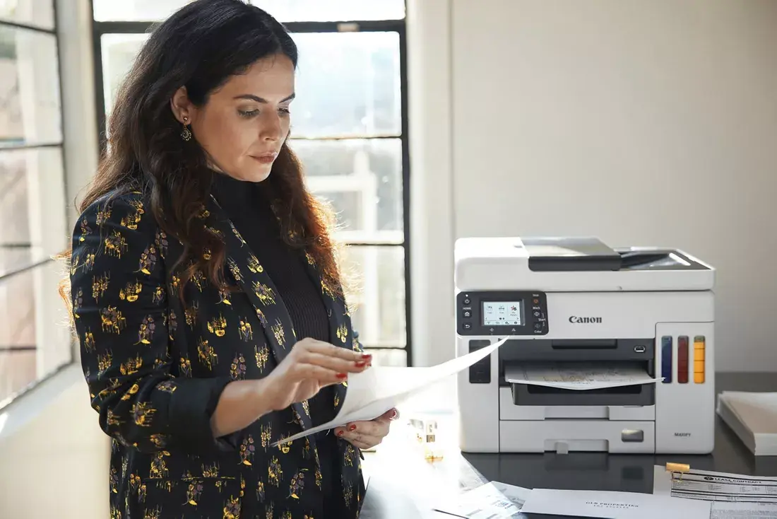 Woman looking at documents printed from her Canon printer