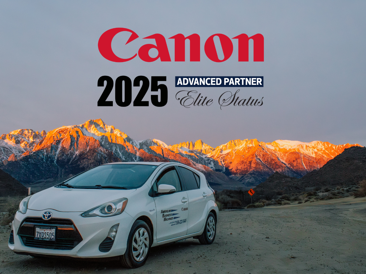 American Business Machines service technician car parked against the Eastern Sierra's with a Canon 2025 Advanced Partner Elite Status logo in foreground