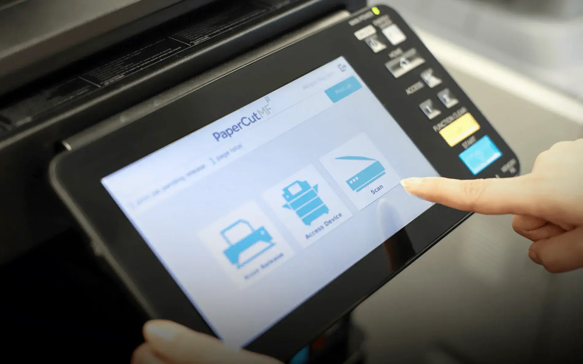 A person using their finger to choose options on PaperCut's software